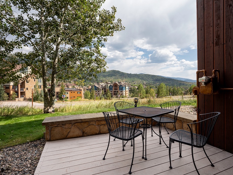 Scenic mountain backdrop surrounds this outdoor dining deck, offering a peaceful setting for morning coffee or al fresco meals during your stay.