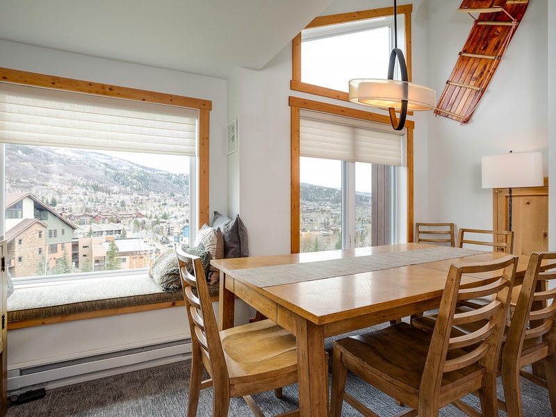 Picture yourself savoring morning coffee at this inviting dining table, surrounded by warm wood tones and natural light. The mountain views create a peaceful backdrop for your meals and conversations.