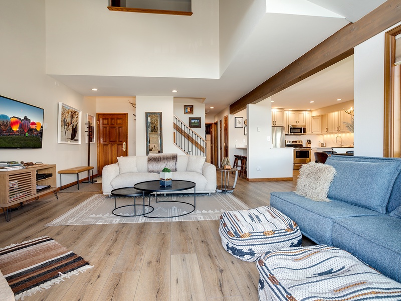 Unwind in your spacious living room with soaring ceilings, plush seating, and an open-concept layout that flows seamlessly into the modern kitchen—perfect for relaxing after a day of adventure.