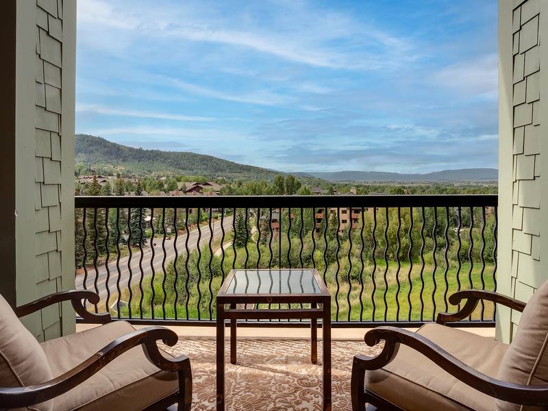 Your private balcony offers sweeping mountain vistas—unwind in comfort as you take in the peaceful hillside and valley views stretching into the distance.