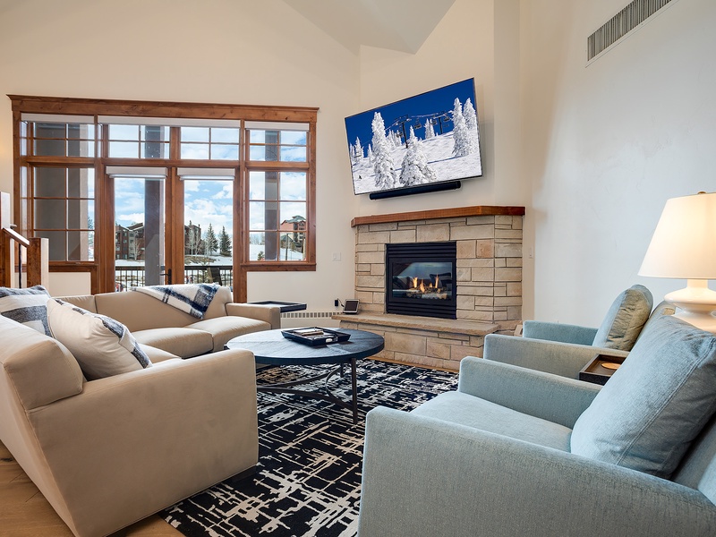 Sink into plush seating by your private fireplace while gazing at mountain views through expansive windows—your perfect après-ski sanctuary awaits.