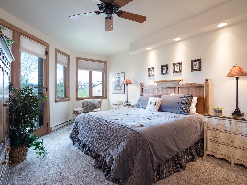 Your peaceful bedroom retreat features a plush king bed, warm wood furnishings, and soft lighting—perfect for unwinding after a day of adventure.