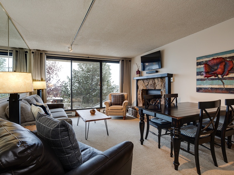 Gather in this inviting living space where your group can unwind after a day of adventure. Large windows frame mountain views, while the fireplace adds warmth on chilly evenings.