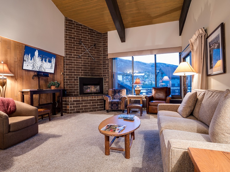Curl up on plush seating by the fireplace and watch the snow-dusted mountains through expansive windows—your perfect mountain retreat awaits.