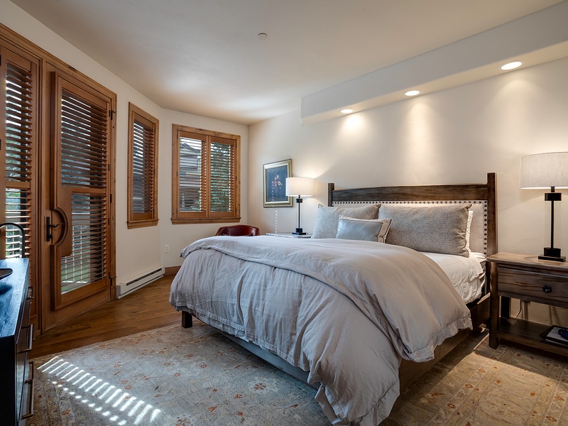Slip into crisp, cloud-soft linens in this thoughtfully designed bedroom, where warm wood tones and tasteful lighting create a restful retreat for your stay.