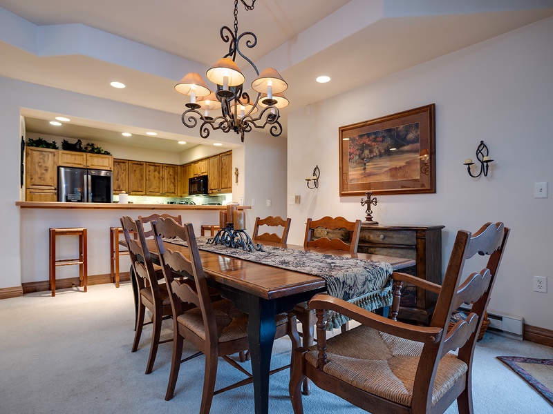 Gather around this inviting dining table for memorable meals together. The open-concept layout connects you to the fully-equipped kitchen, making hosting effortless and fun.