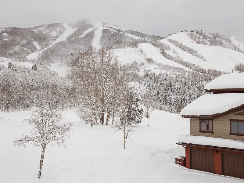 A mountain ski resort property nestled at the base of pristine slopes, offering direct access to winter adventures and stunning alpine scenery.