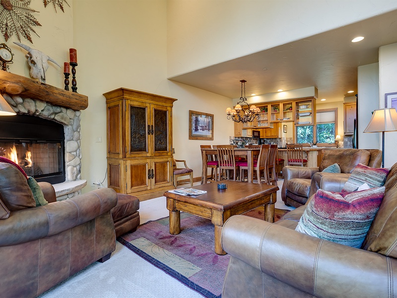 Sink into plush leather sofas by the stone fireplace, gather around the rustic coffee table, or chat at the open kitchen bar—your perfect home base for mountain memories.