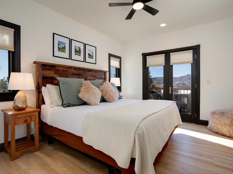 Sink into plush comfort and wake to mountain vistas through your private balcony doors. Warm wood tones and soft textures create your perfect mountain retreat.