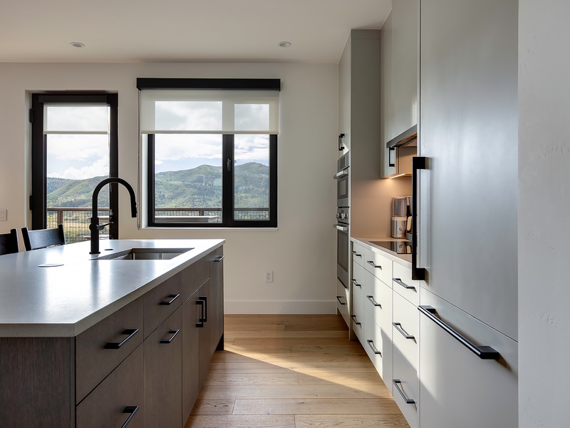 Prepare your favorite meals in this sleek, modern kitchen, where mountain views frame every moment and natural light fills the space.