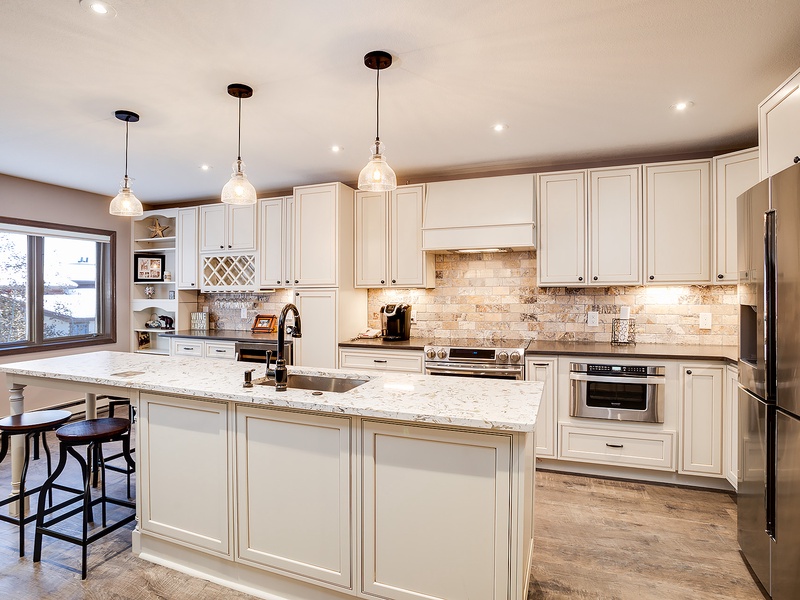 Your gourmet kitchen awaits with gleaming granite countertops, stainless steel appliances, and elegant pendant lighting. The spacious island invites you to gather for meals or plan your daily adventures in this thoughtfully designed space.