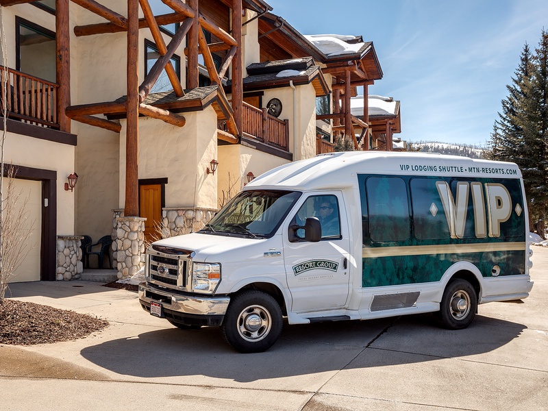 A VIP shuttle service stands ready at the property entrance, offering complimentary transport to nearby mountain slopes and resort amenities.