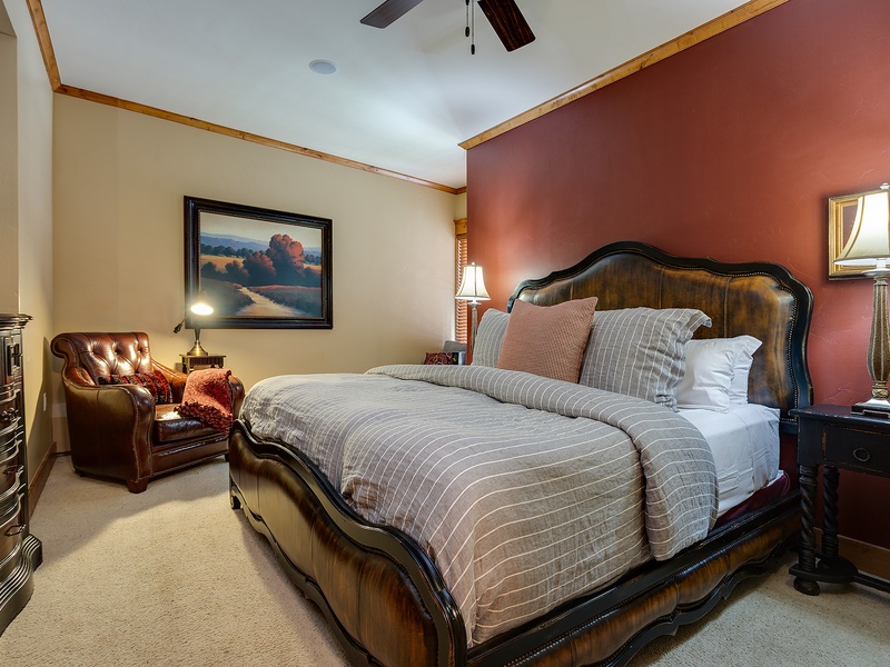 Sink into the plush bedding and unwind in this inviting bedroom, where warm tones and elegant furnishings create a restful retreat after your day's adventures.