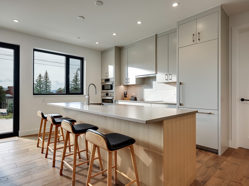 You'll love whipping up meals in this bright, modern kitchen with sleek countertops, ample storage, and a spacious island perfect for morning coffee or gathering with friends.
