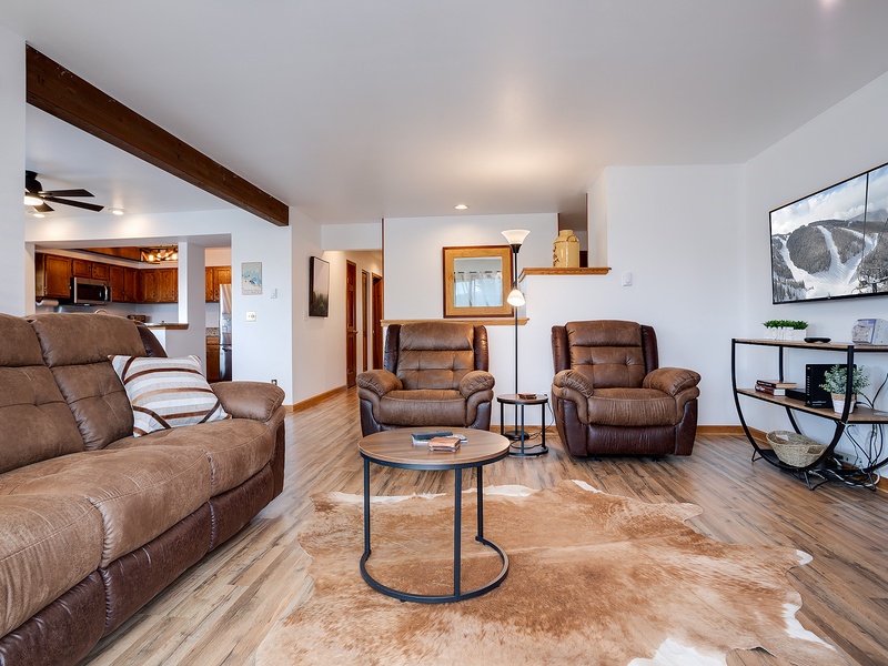 Sink into plush recliners and unwind in your spacious living room, where wood beams and mountain views remind you you're truly on vacation.