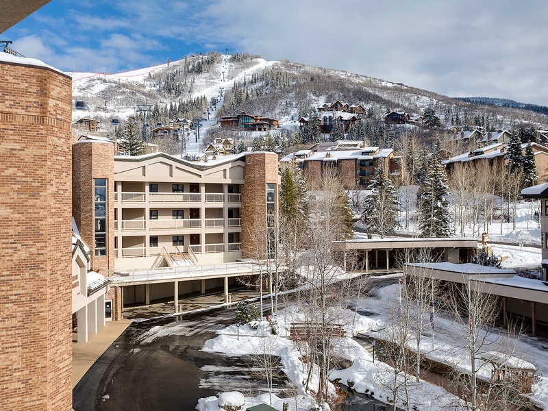 Stunning winter mountain views frame this ski resort property, surrounded by snow-dusted peaks and alpine slopes. A premier setting for your next mountain getaway.