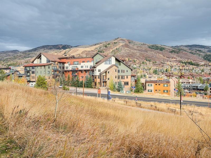 The property sits nestled in a mountain valley community, surrounded by dramatic peaks and seasonal foliage. A peaceful neighborhood setting with convenient access to local amenities.