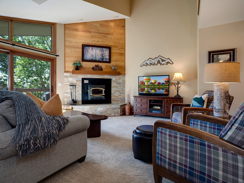 Sink into cozy seating by your private fireplace, where mountain views and rustic-modern design create the perfect retreat after a day of adventure.