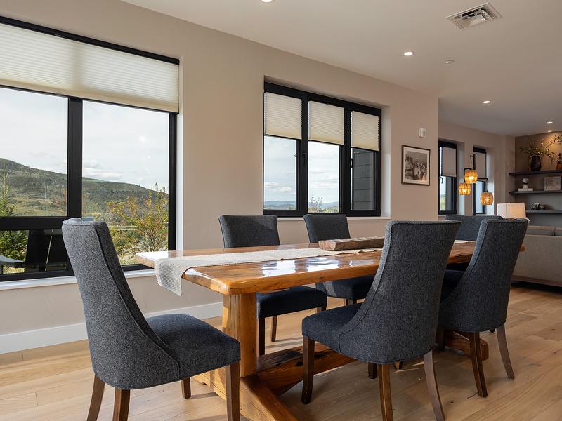 Gather around this warm wood dining table and share meals while taking in stunning mountain views. Thoughtful design blends modern comfort with natural beauty—your perfect mountain retreat awaits.