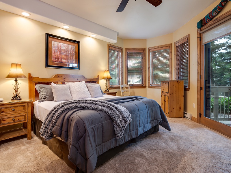 Drift off in your cozy mountain retreat, where warm wood tones and soft bedding invite deep relaxation. Step onto your private balcony for fresh alpine air.