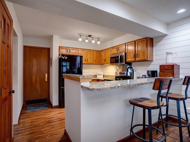 Your fully equipped kitchen awaits with granite countertops, stainless appliances, and a breakfast bar where you can sip morning coffee and plan your day.