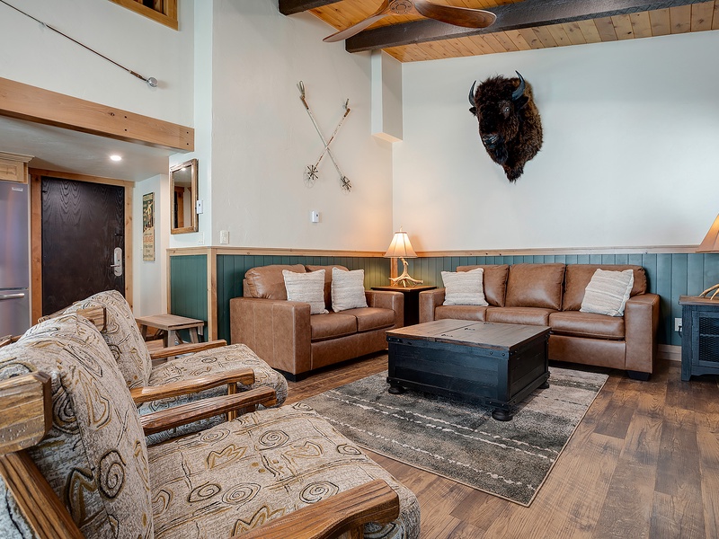 Unwind in your inviting living room where rustic charm meets comfort—perfect for gathering after a day of mountain adventures.