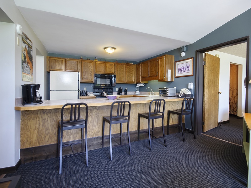 Step into your fully-equipped kitchen with breakfast bar seating, where you can whip up meals or sip morning coffee in comfortable style.