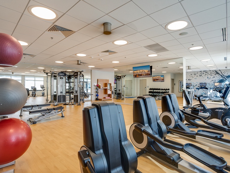 Your private fitness center features cardio machines, free weights, and exercise balls—everything you need to maintain your workout routine during your stay.