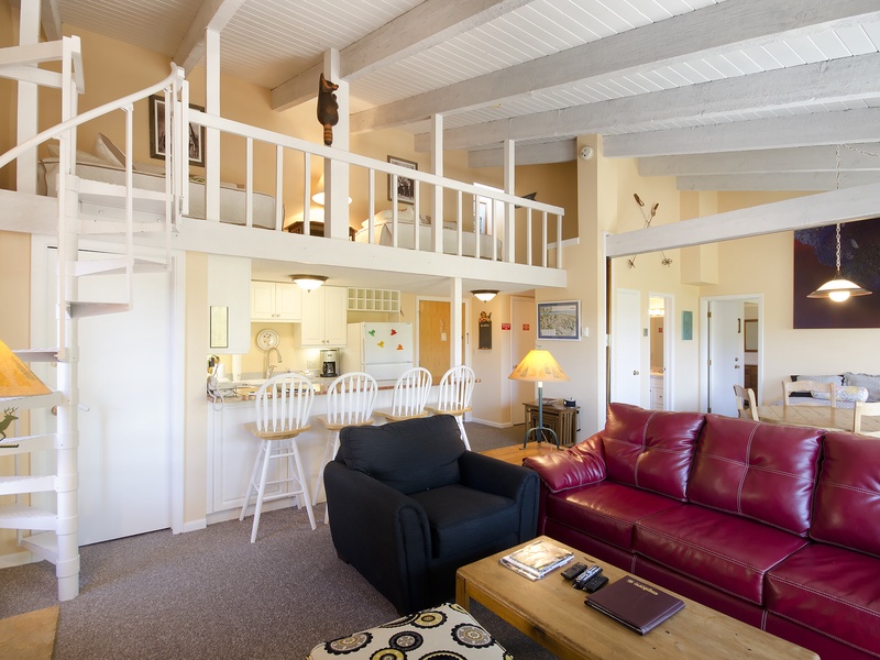 Step into your spacious open-plan retreat with soaring ceilings, a cozy loft, and a full kitchen—your perfect home base for unforgettable getaways.