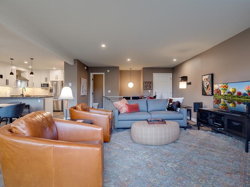 Sink into rich leather chairs and your plush sofa as you unwind with shows on the big screen. The open kitchen invites easy meal prep while you stay connected to the cozy living space.