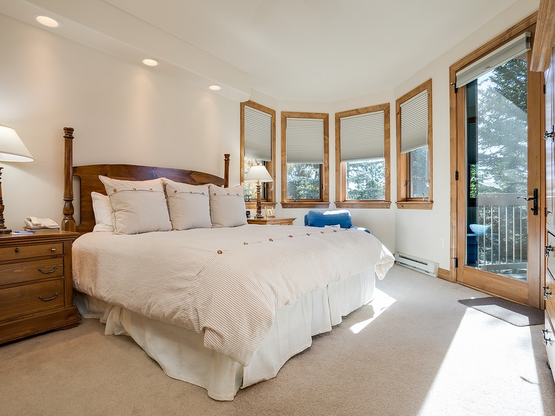 Sink into plush bedding and wake to mountain views through your private balcony door. Natural light fills your peaceful retreat with warm wood accents and everything you need to unwind.