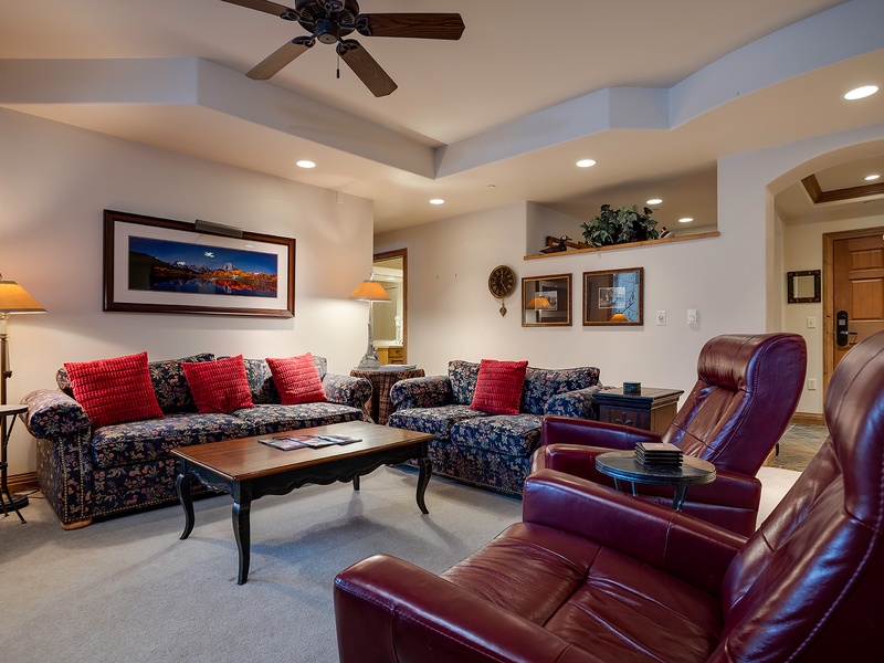 Sink into plush seating and unwind in your thoughtfully designed living room, where rich leather recliners and cozy sofas invite you to relax after a day of mountain adventures.