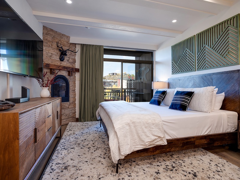 Drift off to sleep in your cozy king bed, warmed by the rustic fireplace and framed by mountain vistas beyond your private balcony.