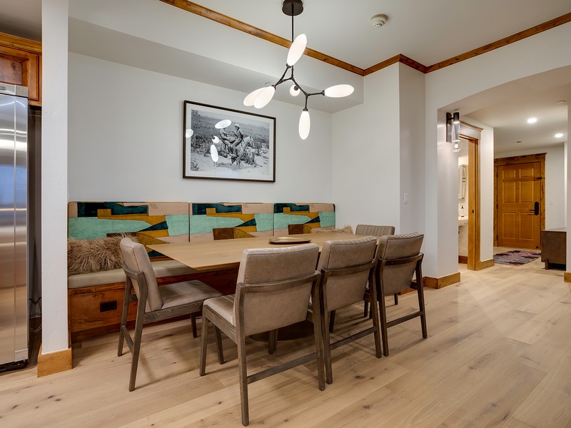 Gather your group around this spacious dining table with built-in banquette seating, perfect for shared meals and conversation in your mountain retreat.