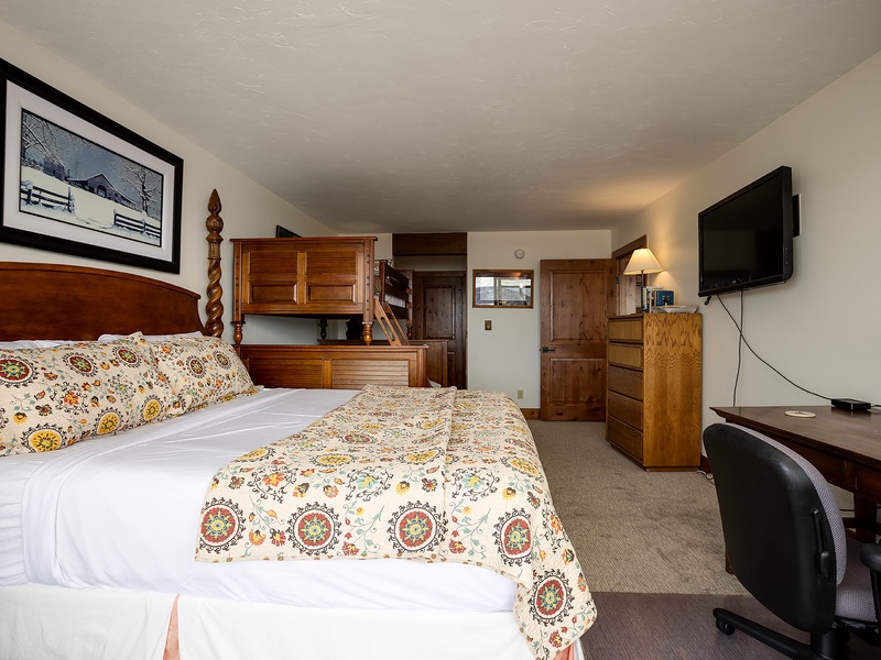 Settle into your cozy retreat with a beautifully dressed bed, warm wood furnishings, and all the comforts of home—including a flat-screen TV and dedicated workspace for your mountain getaway.