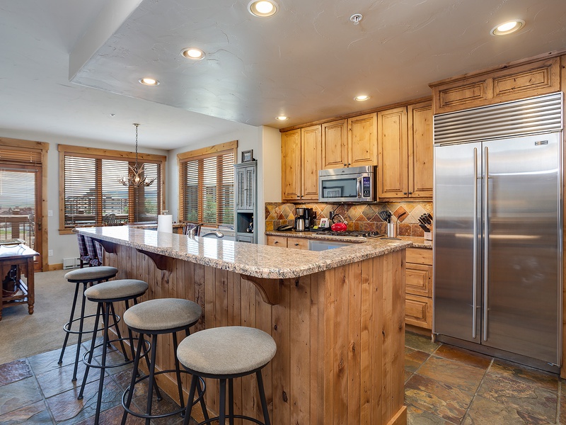 Your fully-equipped kitchen invites easy meal prep, with granite countertops, stainless steel appliances, and a spacious island for gathering over morning coffee or evening appetizers.