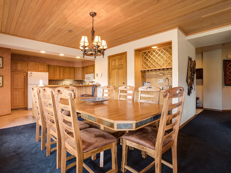 Gather around this spacious dining table with seating for eight, perfect for sharing meals and making memories together. The open-plan kitchen and elegant wood finishes create a warm, inviting atmosphere.