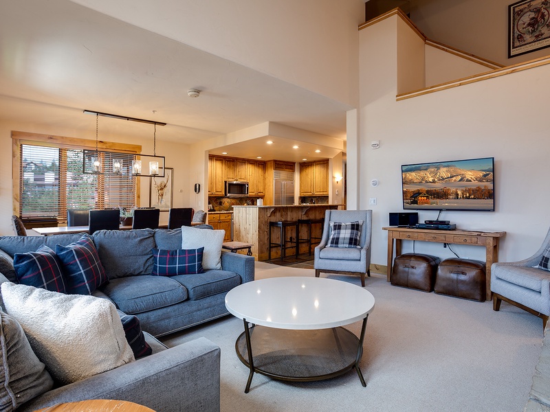 Sink into plush seating and unwind in your spacious living room, where mountain views on the big screen and an open kitchen invite effortless relaxation and togetherness.