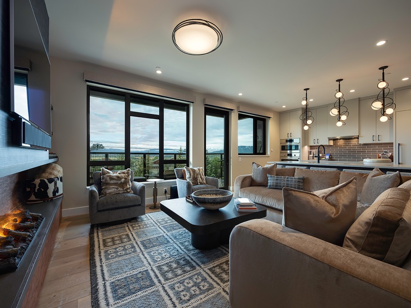 Sink into plush sofas by the fireplace and let the stunning landscape views through floor-to-ceiling windows become your favorite daily backdrop.