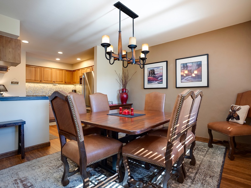Gather around this inviting dining space where sunlight streams through, creating a warm ambiance for your meals. The open kitchen layout makes entertaining effortless and enjoyable.