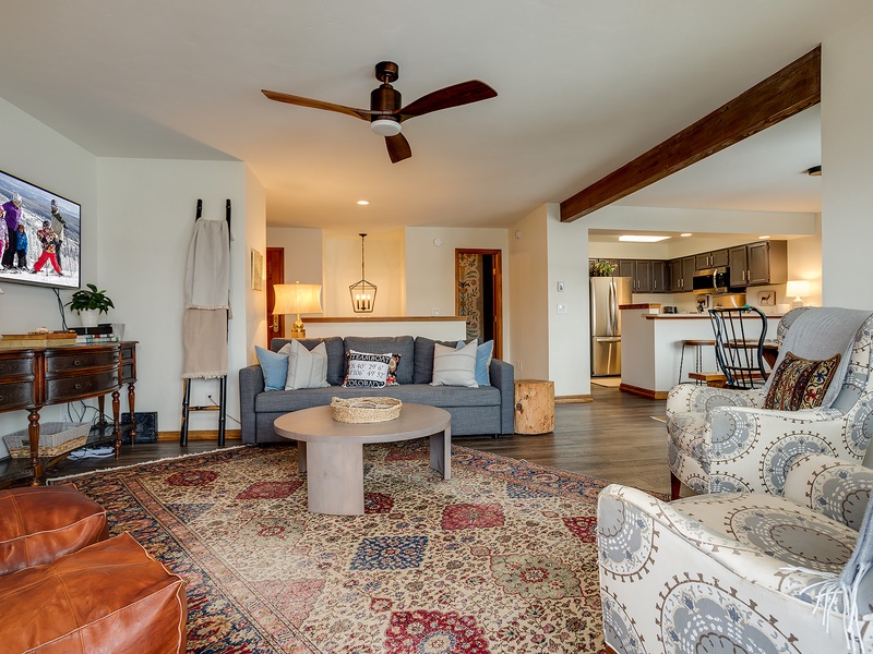 Unwind in this welcoming living space with cozy seating, ceiling fan, and open flow to your fully-equipped kitchen—perfect for relaxing evenings together.