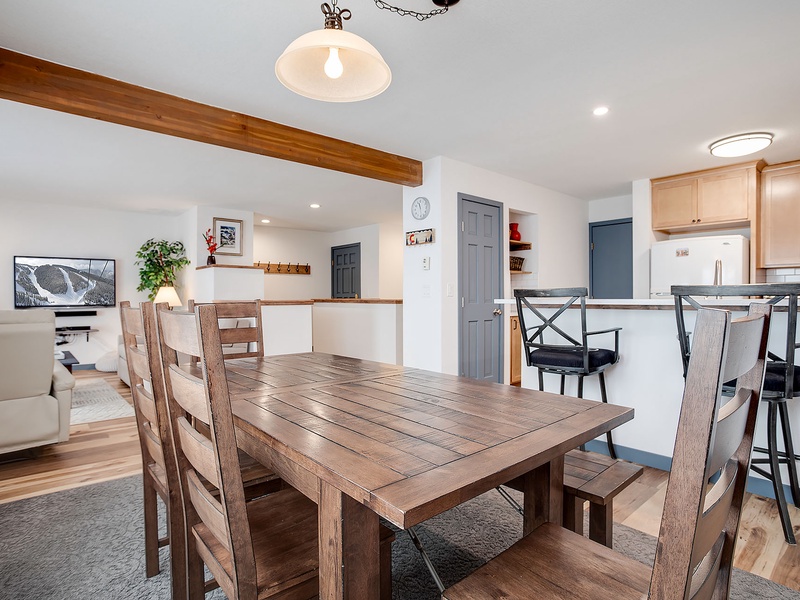 Gather around this beautiful rustic dining table with your travel companions, where warm wood tones and open-concept design create the perfect space for sharing meals and making memories together.