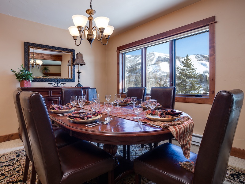 Gather around the elegant dining table where mountain vistas frame every meal, creating unforgettable moments with those you love most.