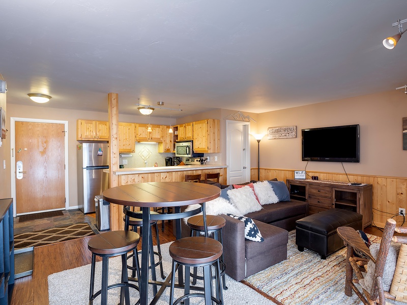 Step into this inviting open-concept space where the kitchen flows seamlessly into your living and dining areas. Warm wood tones and modern touches create a cozy mountain retreat vibe perfect for relaxing after a day of adventure.