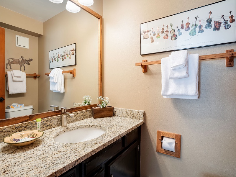 Step into your own private oasis with a spacious granite vanity, artistic touches, and fresh white linens waiting to welcome you after a day of adventure.