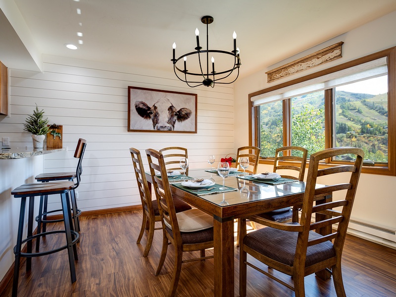 Gather around this inviting dining table where shared meals feel even more special. Bright mountain views frame every conversation, and rustic farmhouse charm creates a warm, welcoming atmosphere for your group.