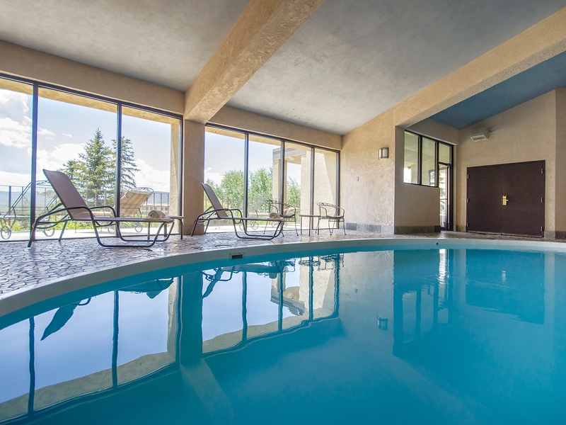 Slip into crystal-clear waters in your private indoor pool, where floor-to-ceiling windows frame stunning mountain vistas. Lounge poolside and let natural light wash over you as you unwind in complete tranquility.