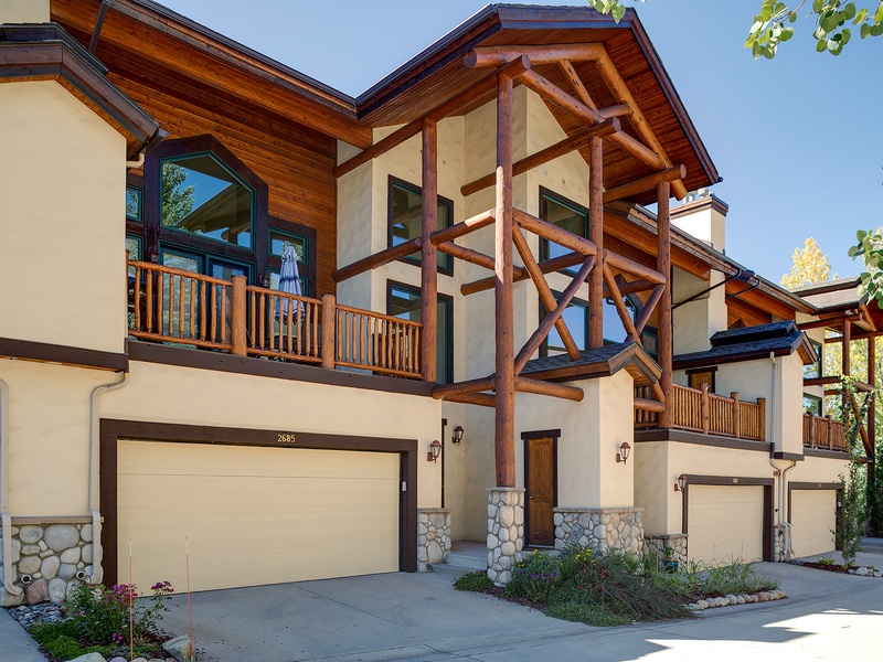 A stunning mountain-style property with exposed timber beams, spacious balconies, and stone accents that blend modern comfort with alpine charm in a serene natural setting.