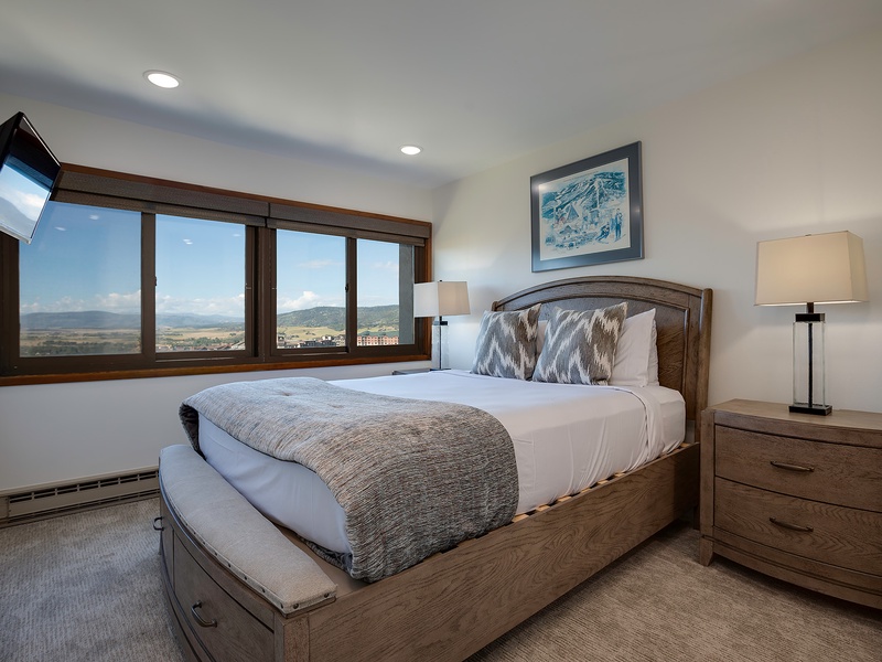 Drift off in your serene bedroom, where sweeping mountain views frame the horizon and cozy bedding invites peaceful sleep. Wake to natural light and breathtaking scenery.