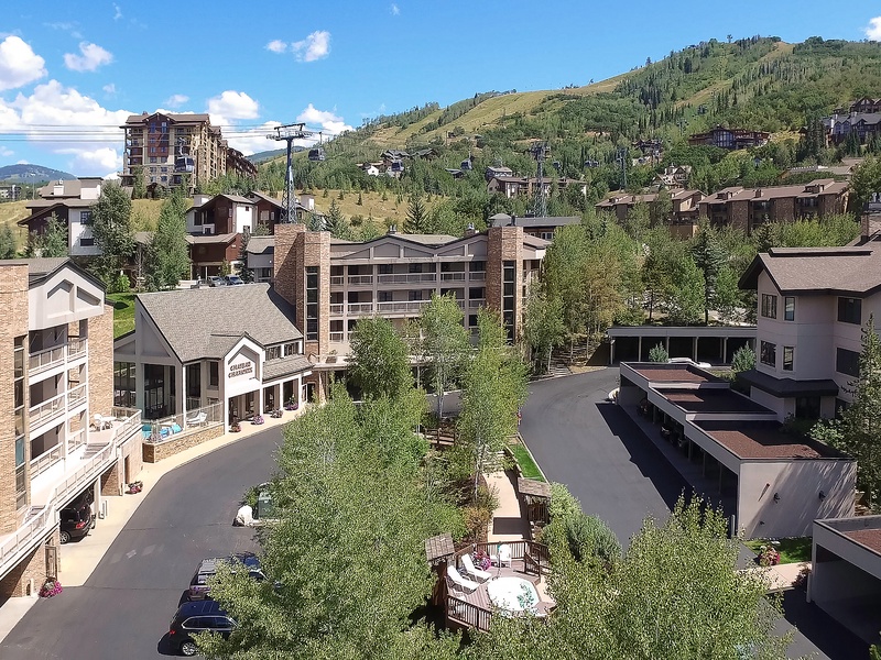 Nestled in a picturesque mountain valley, this alpine village setting offers a scenic backdrop of forested slopes and ski areas, with nearby parking and convenient access to local amenities.